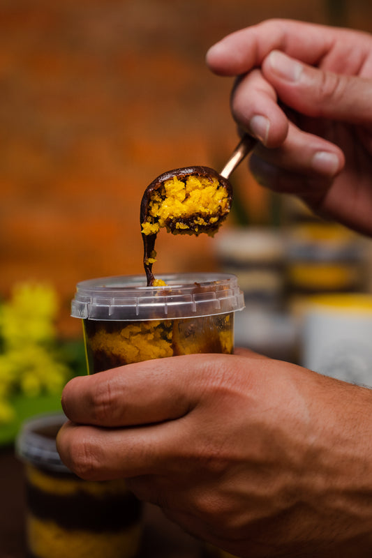 Carrot cake, filled with brigadeiro being delightful spoonful with a copper spoon  